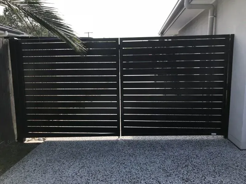A Black Gate is Sitting in Front of a House — Sunshine Gates in Kunda Park, QLD