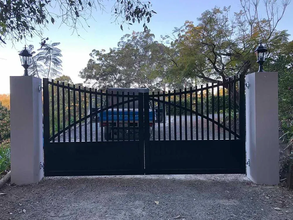 A Black Gate With a Blue Car Parked Behind It — Sunshine Gates in Kunda Park, QLD