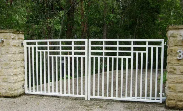 A White Gate is Surrounded by Stone Pillars and Trees — Sunshine Gates in Kunda Park, QLD