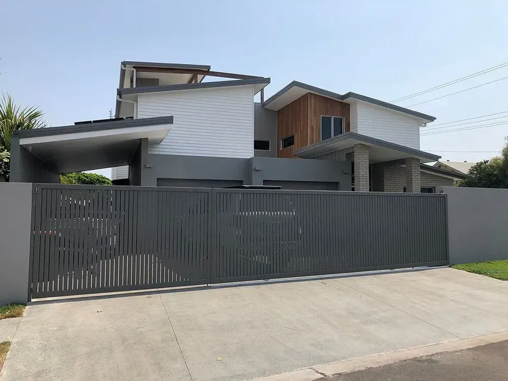 A Large House With a Sliding Gate in Front of It — Sunshine Gates in Kunda Park, QLD