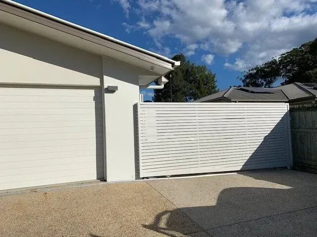 A Large House With a Sliding Gate in Front of It — Sunshine Gates in Kunda Park, QLD