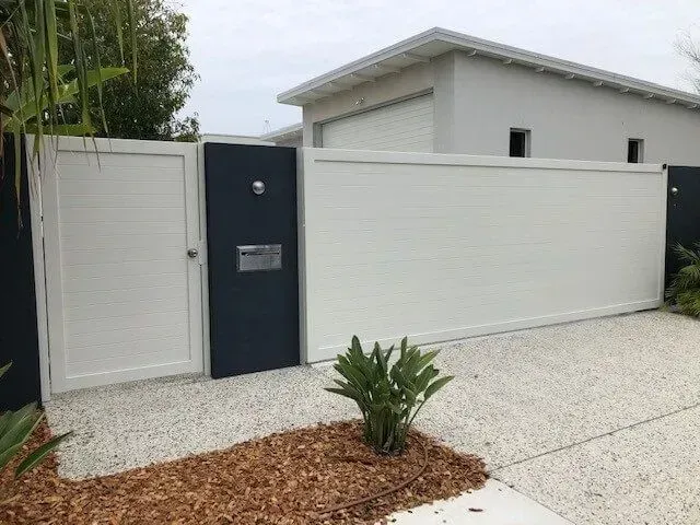 A White Fence With a Black Gate in Front of a House — Sunshine Gates in Kunda Park, QLD