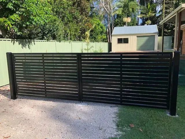 A Black Fence is Sitting in Front of a House — Sunshine Gates in Kunda Park, QLD