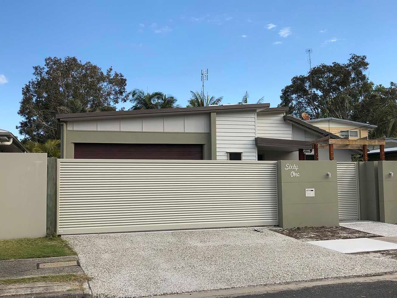 A House With a Sliding Gate in Front of It — Sunshine Gates in Kunda Park, QLD