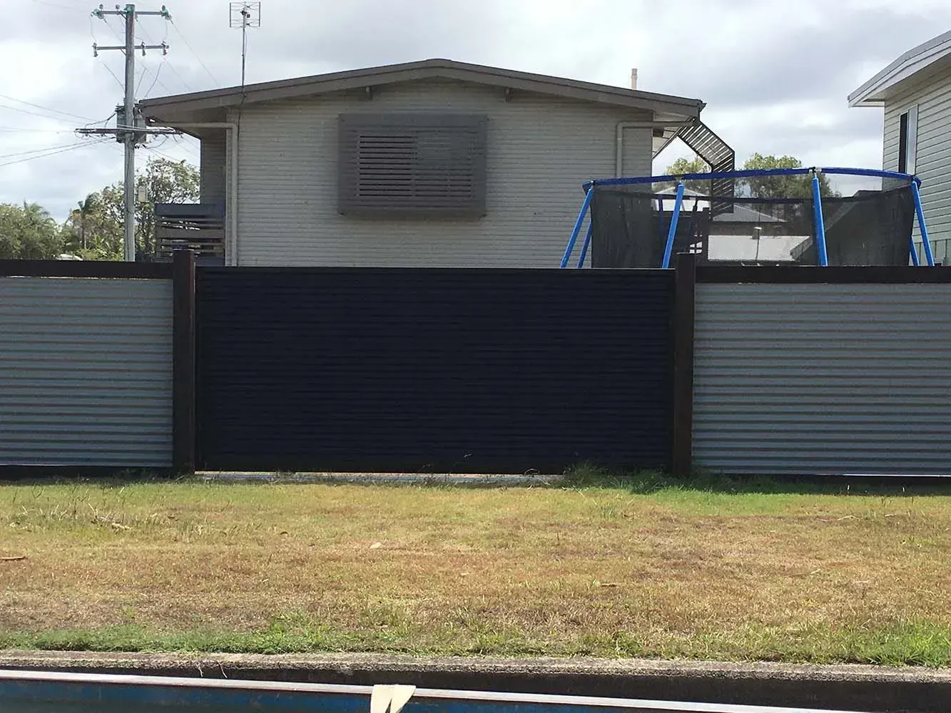 A House With a Swing Set Behind a Fence Next to a Pool — Sunshine Gates in Kunda Park, QLD