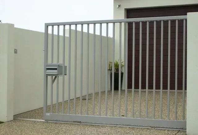 A Sliding Gate is Open to a Driveway in Front of a House — Sunshine Gates in Kunda Park, QLD