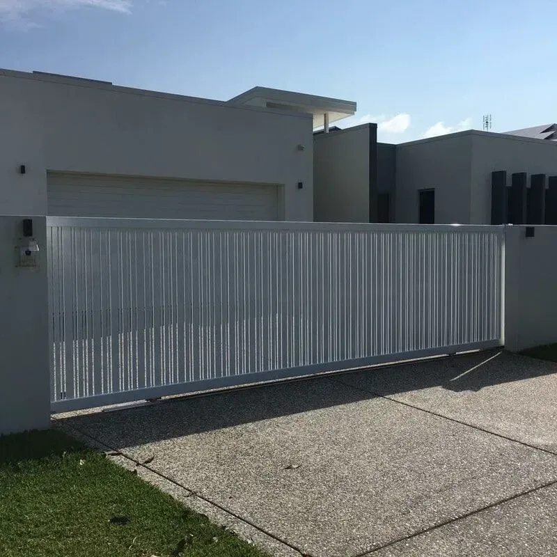 A White Sliding Gate is in Front of a White House — Sunshine Gates in Kunda Park, QLD