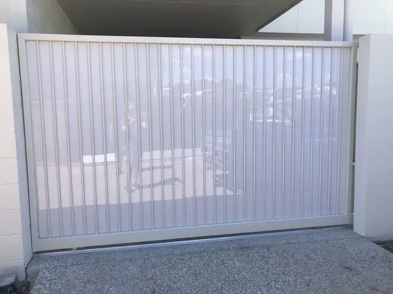 A White Sliding Gate is Open to a Driveway — Sunshine Gates in Kunda Park, QLD