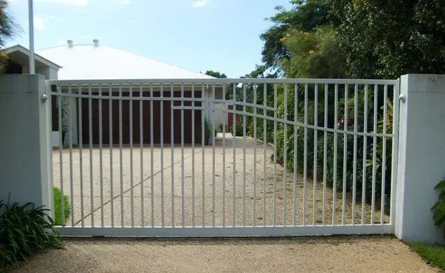 A White Gate is Open to a Driveway in Front of a House — Sunshine Gates in Kunda Park, QLD