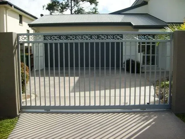 A Sliding Gate is Open to a Driveway in Front of a House — Sunshine Gates in Kunda Park, QLD