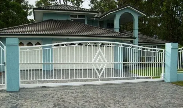 A Large House With a White Gate in Front of It — Sunshine Gates in Kunda Park, QLD