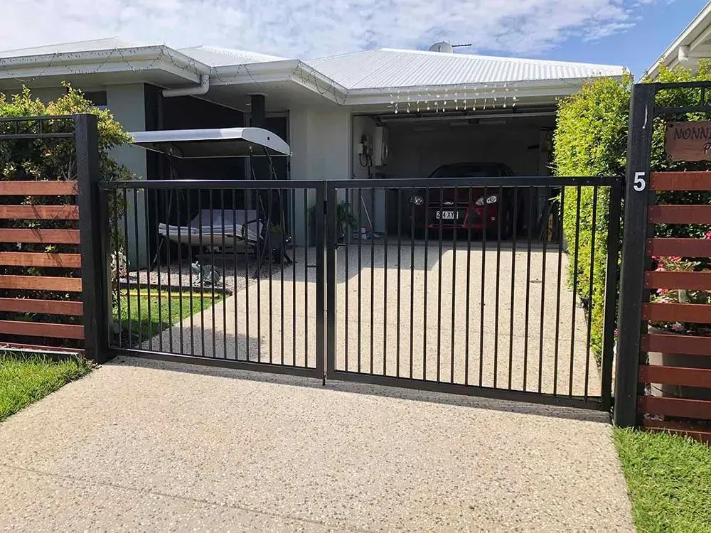 A Car is Parked in the Driveway of a House Behind a Gate — Sunshine Gates in Kunda Park, QLD