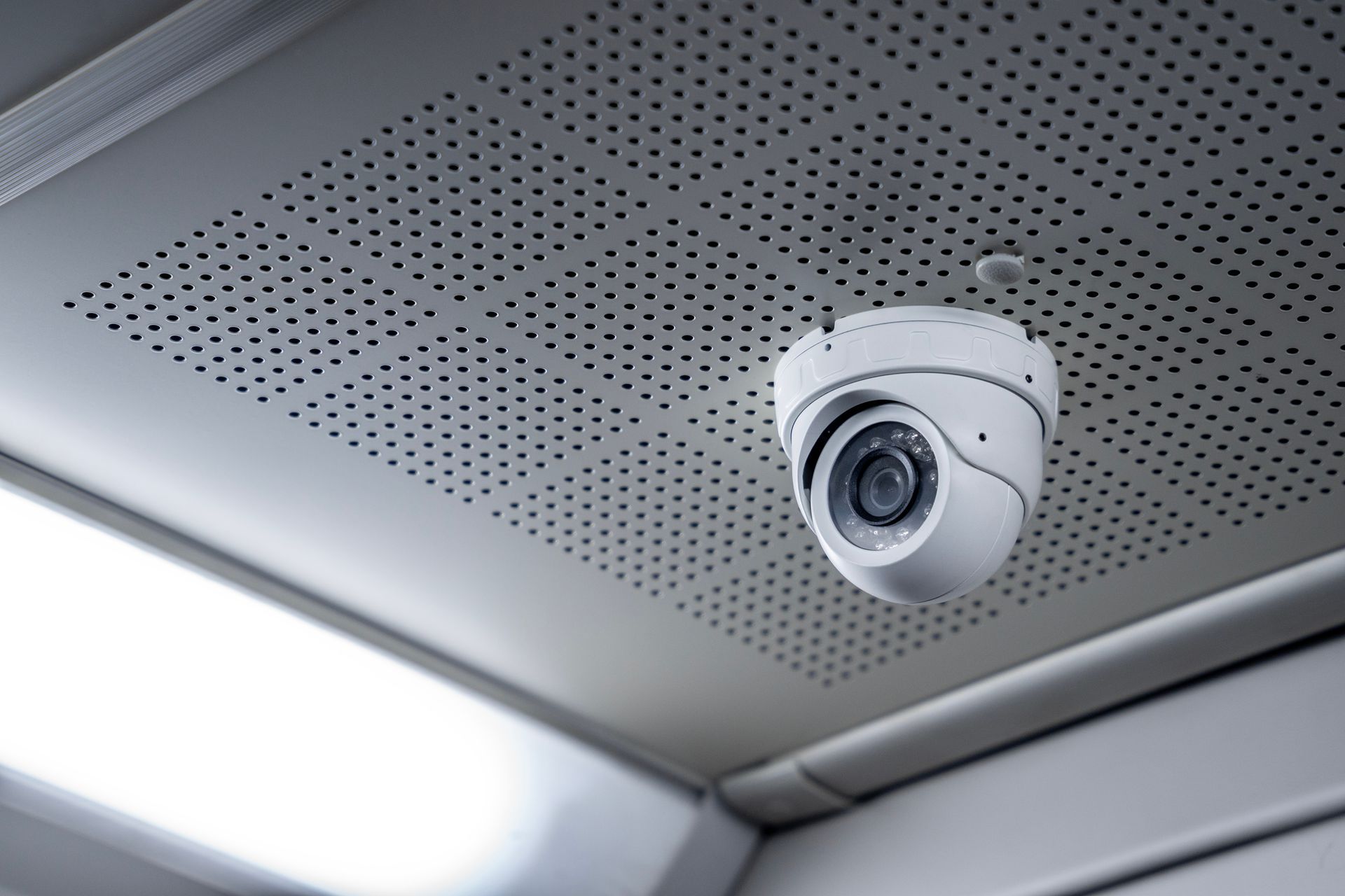 Ceiling-mounted security camera in a modern indoor corner