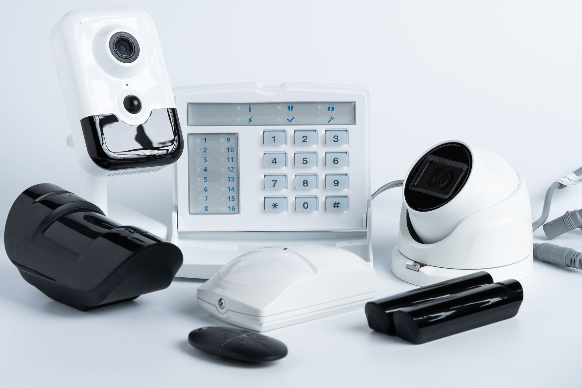 Assistive technology devices in white and black, including a keypad, head pointer, and trackball mouse