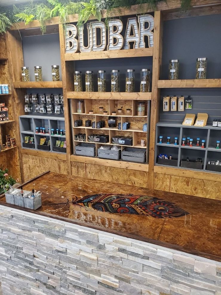 Woodbar café display with shelves of coffee equipment, jars, and wood-paneled decor