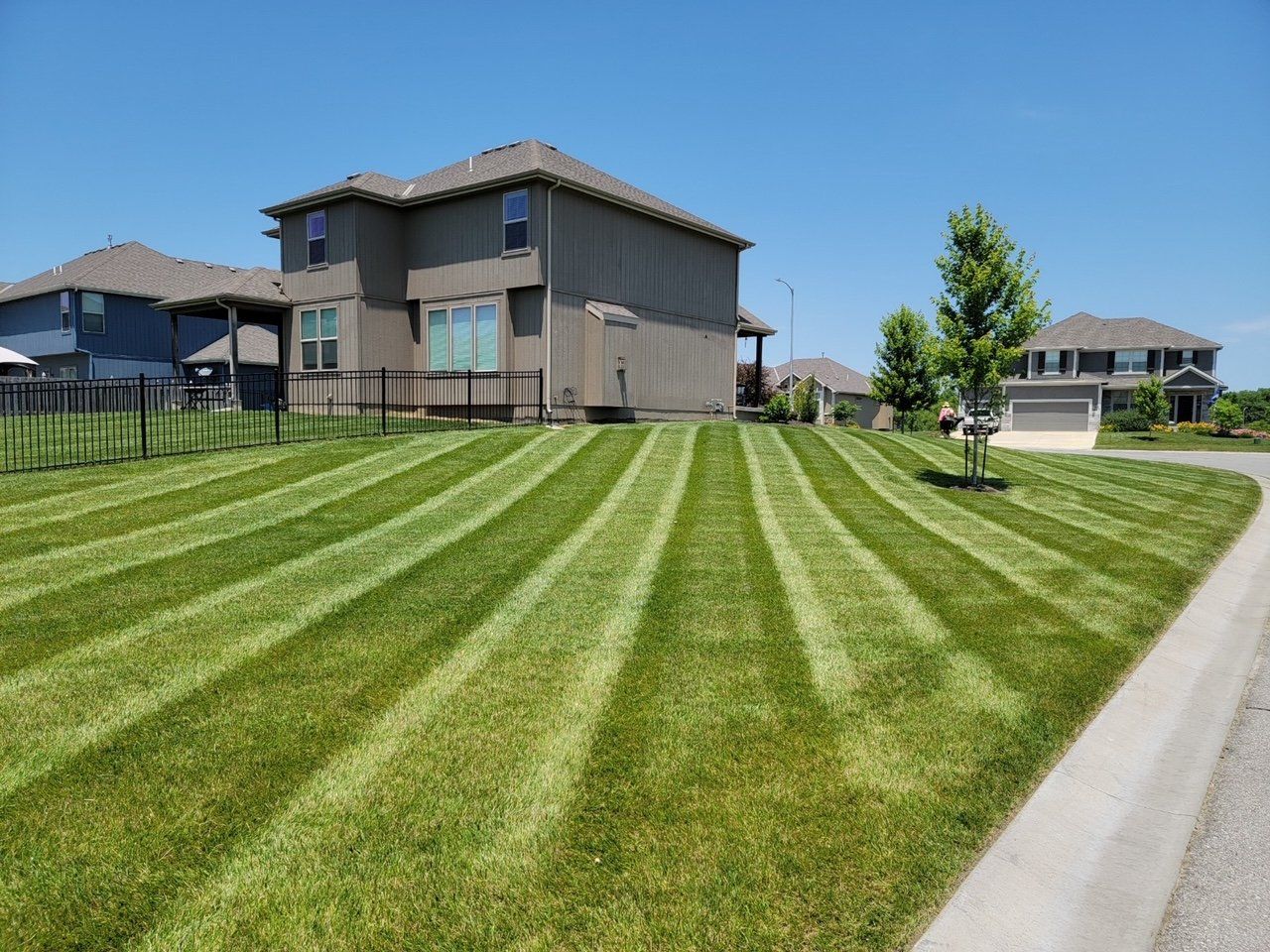 A large house with a lush green lawn in front of it.