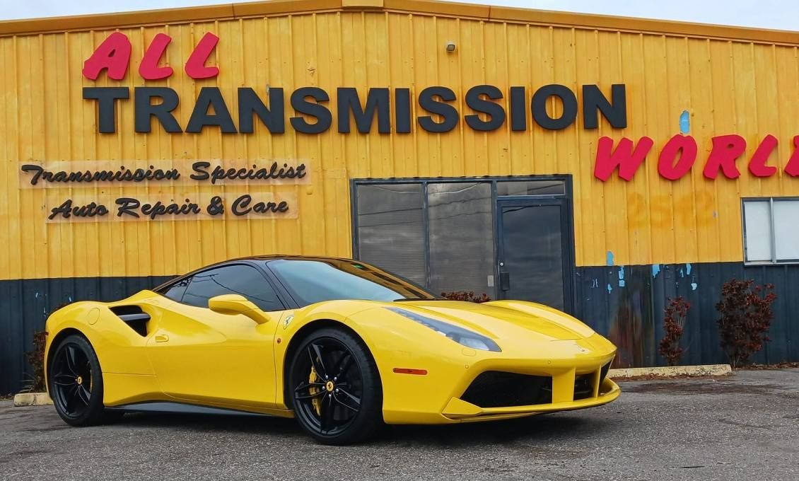Yellow sports car parked outside All Transmission World auto repair shop