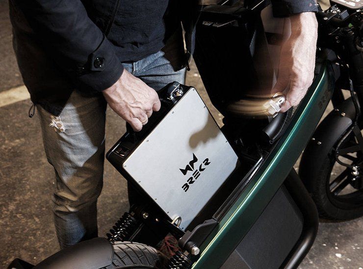 A man is holding a box that says mv on it