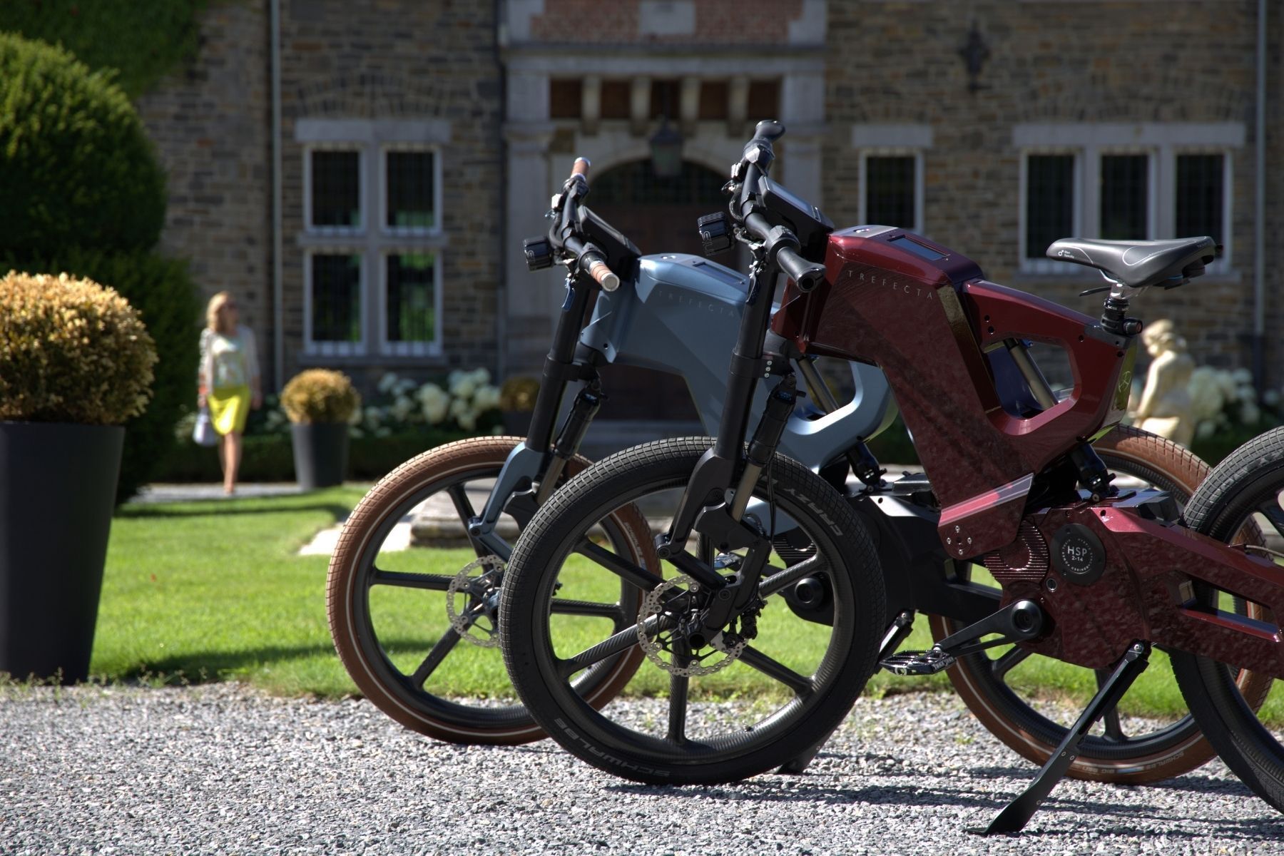 Two bicycles are parked in front of a brick building.