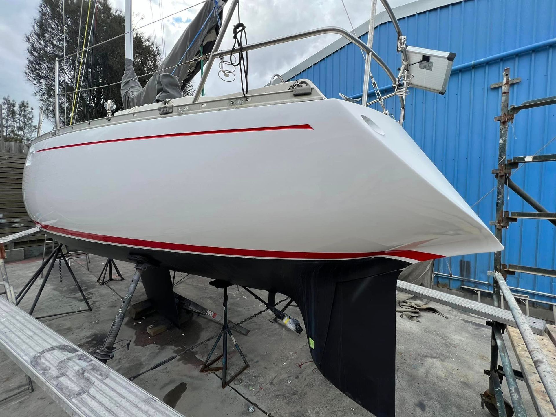The man finished spray painting a boat | Marmong Point, NSW | On Point Shipwright Group