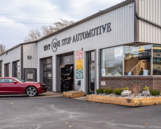 A red car is parked in front of why one stop automotive | WNY One Stop Automotive