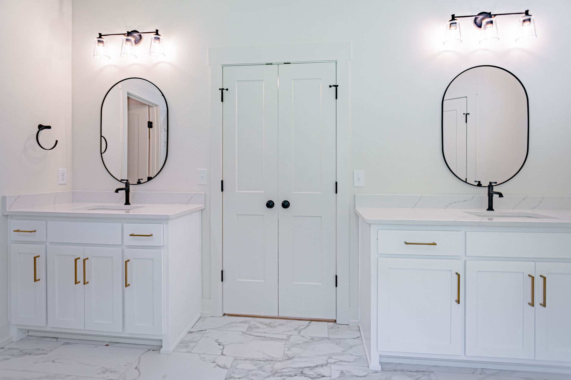 A bathroom with two sinks and two mirrors.