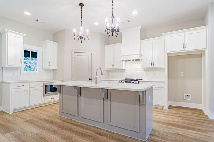 There is a large island in the middle of the kitchen.