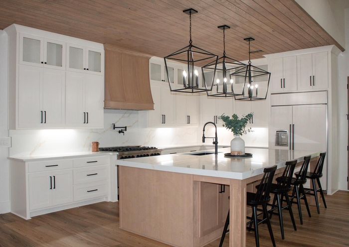 There is a large island in the middle of the kitchen.