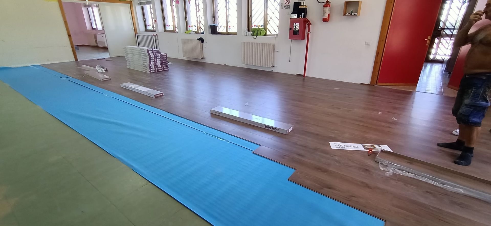 Un uomo è in piedi in una stanza con un tappetino blu sul pavimento.