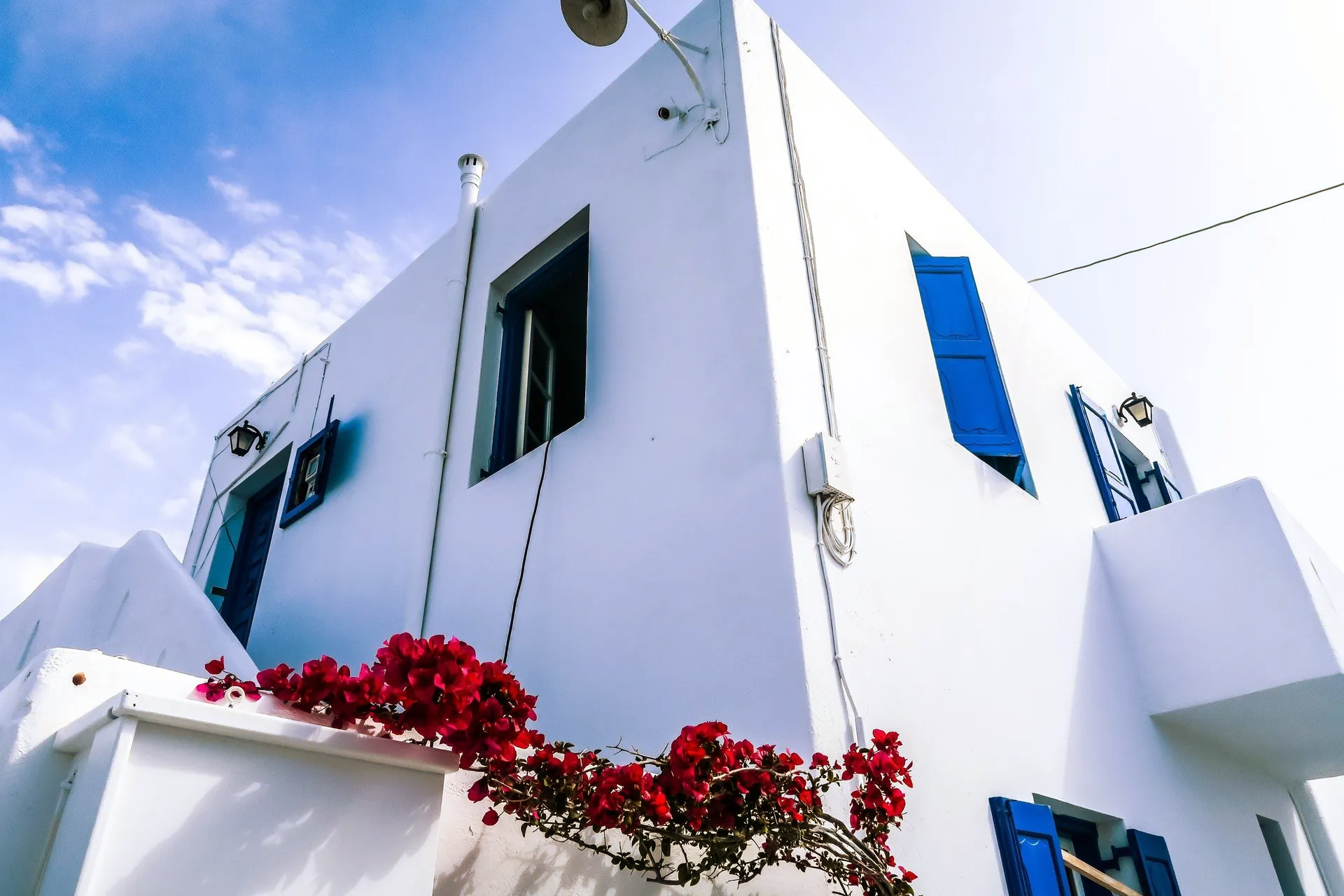 outside of house painted white with blue shutters