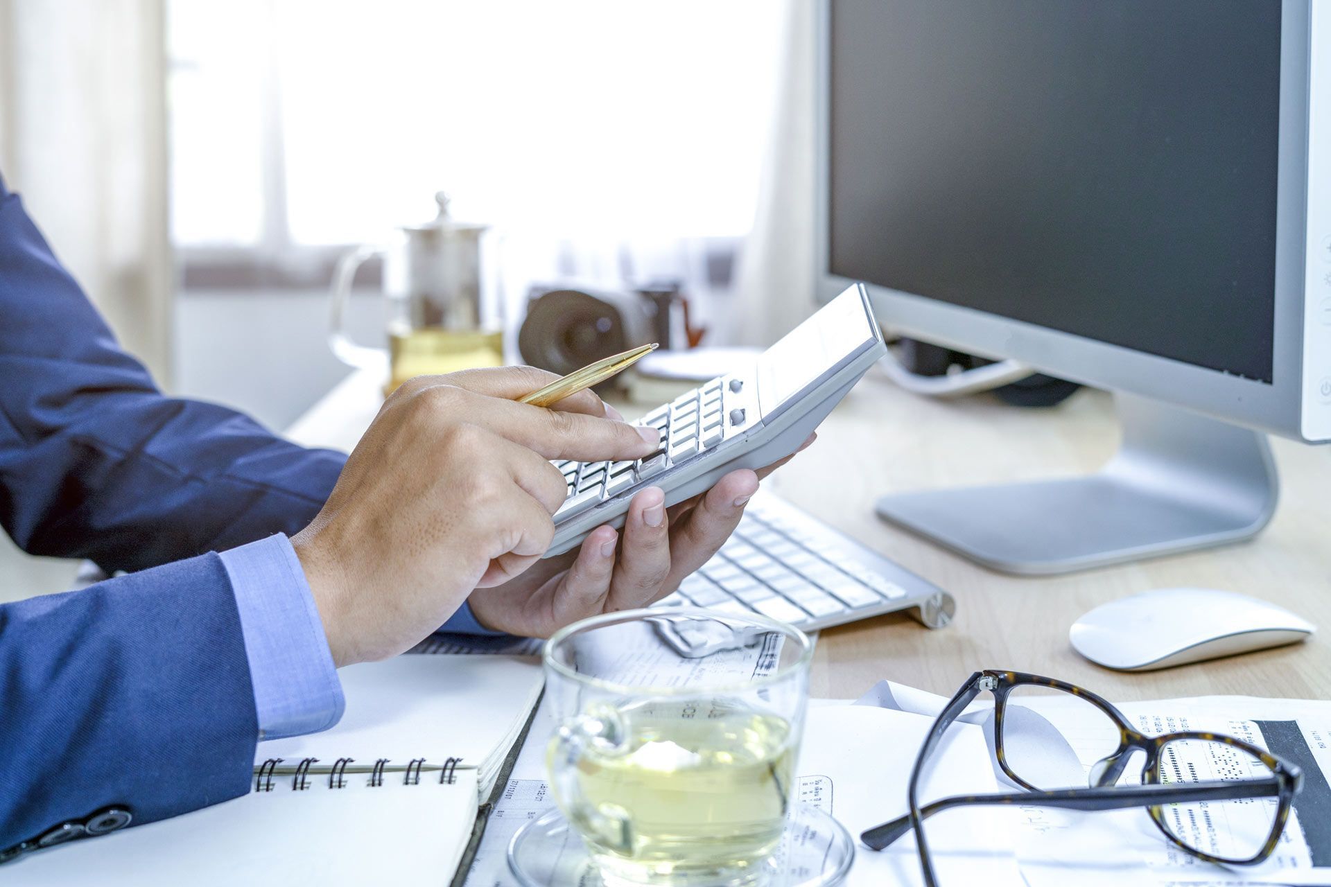 A Man Computing with a Tea on the Table | Brisbane Qld | Mta-More Than Accountants Pty Ltd A Man Computing with a Tea on the Table | Brisbane Qld | Mta-More Than Accountants Pty Ltd