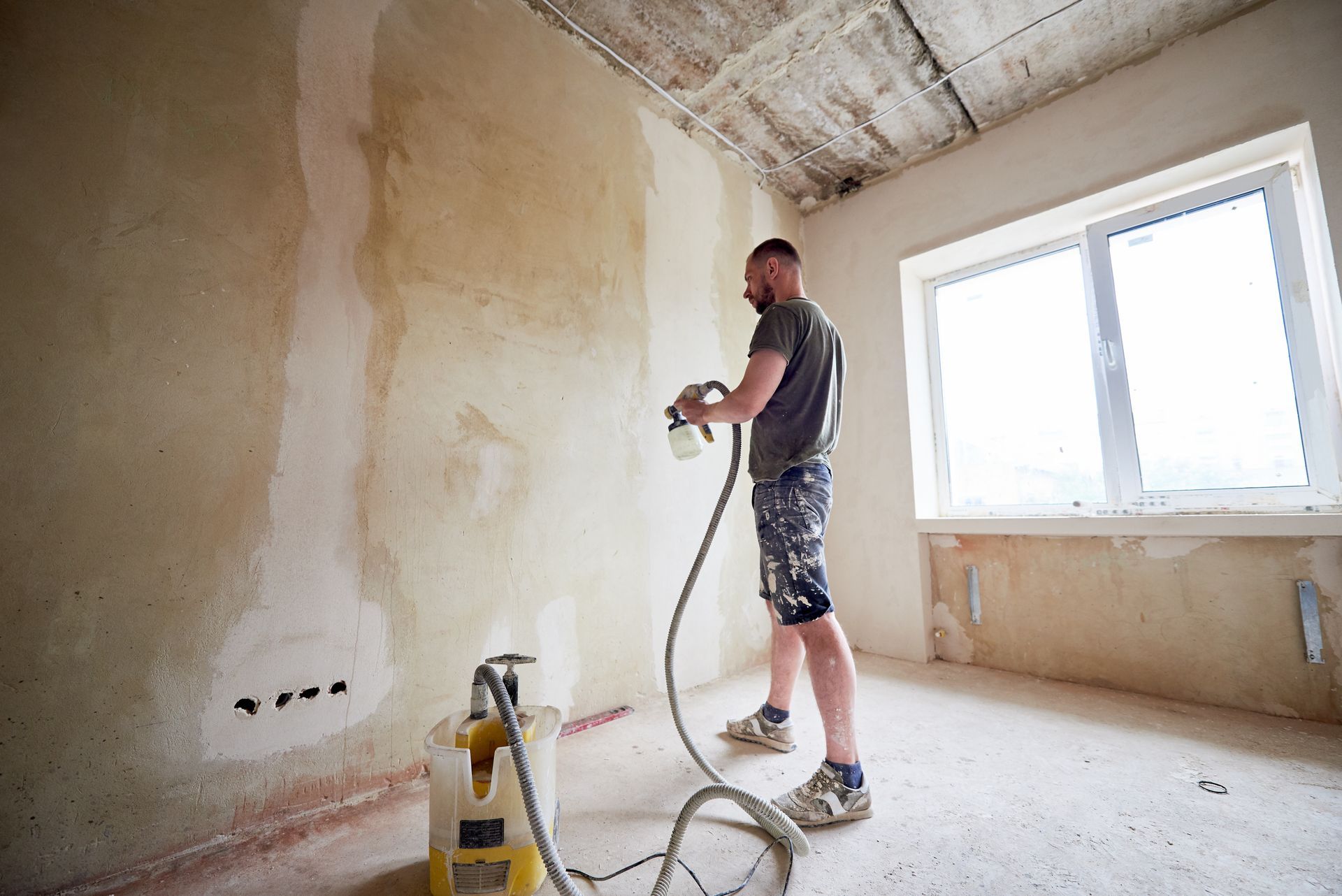 a guy painting a wall.