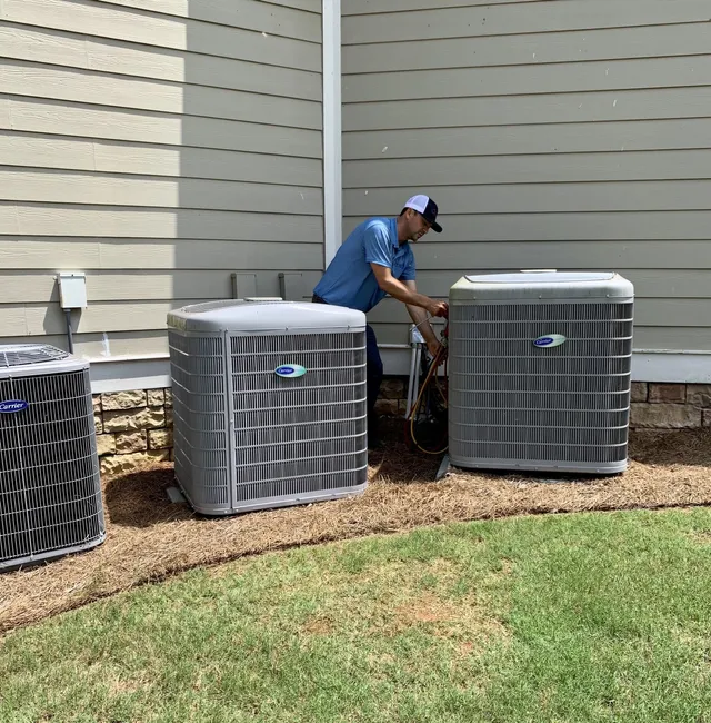 Air Conditioning Maintenance — Man Checking New Air Condition in Bogart, GA Air Conditioning Maintenance — Man Checking New Air Condition in Bogart, GA
