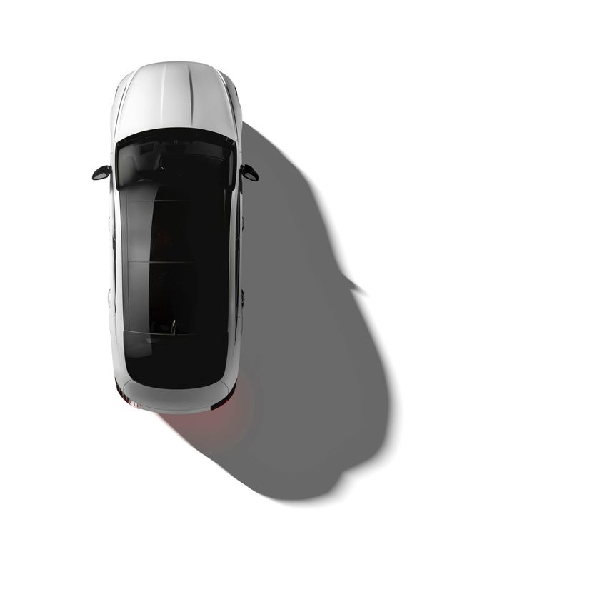 Top-down view of a white car casting a long shadow on a light background