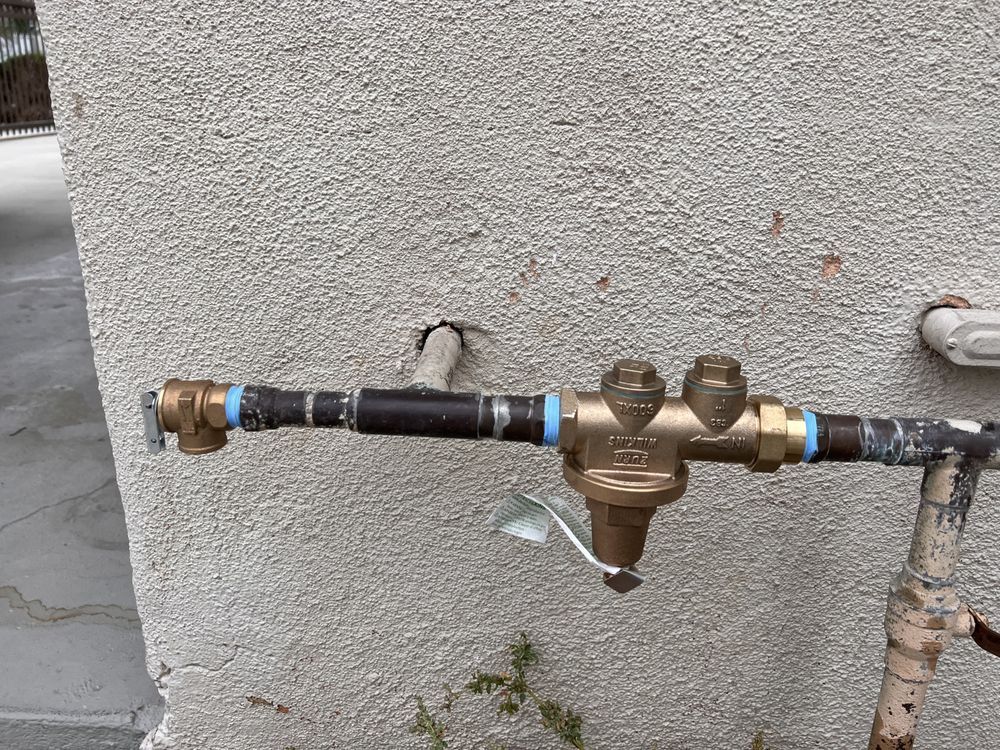 A close up of a faucet on a wall.
