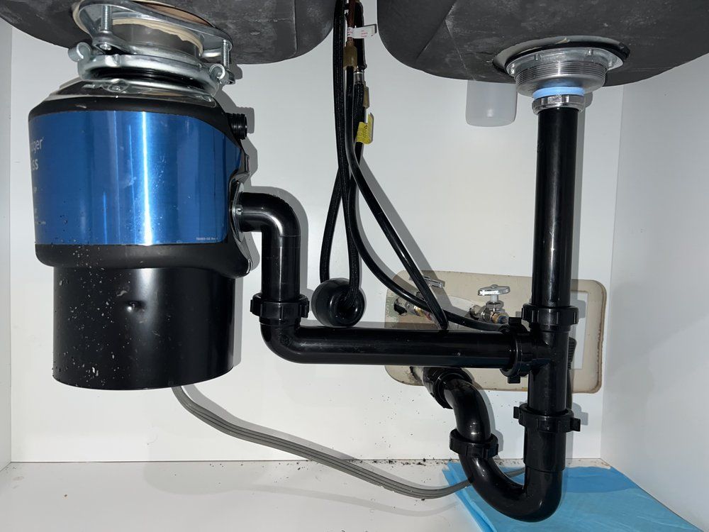 A sink with a garbage disposal underneath it
