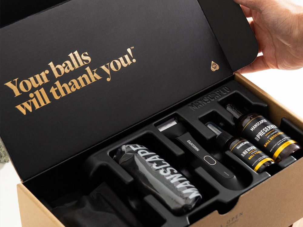 Open gift box with workout supplements and shaker bottle inside, slogan: “Your balls will thank you.”