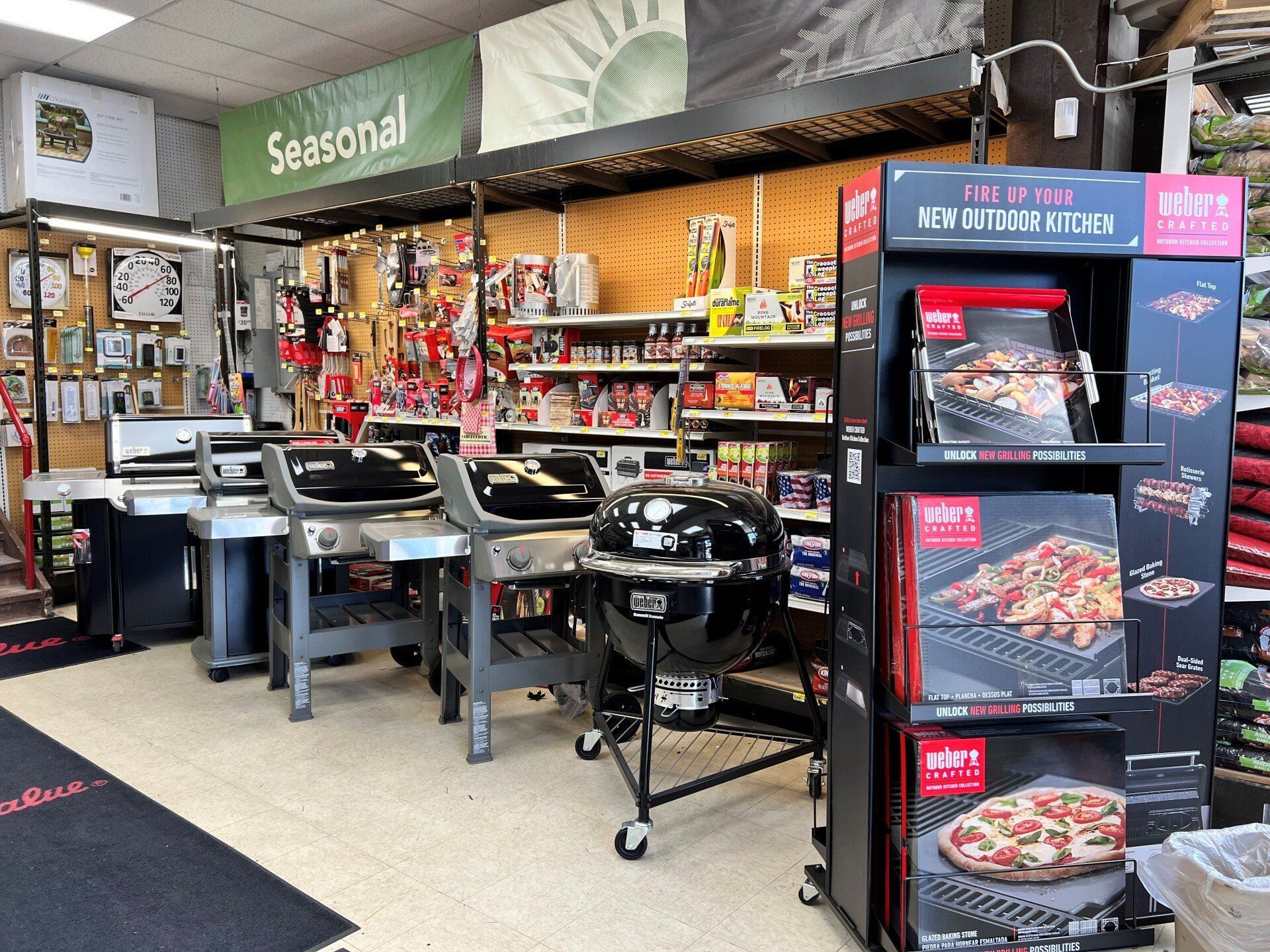 Grills and accessories displayed in a retail store, with