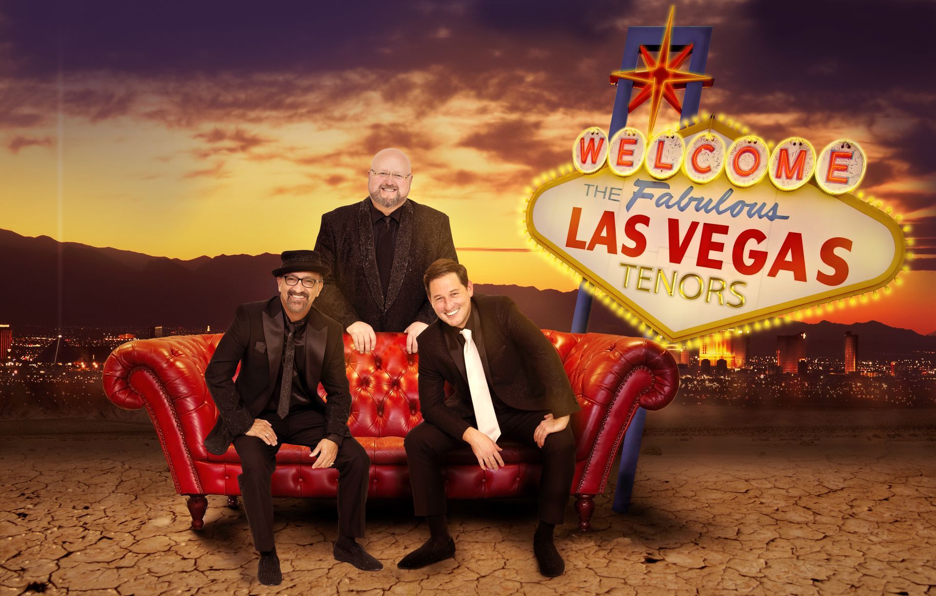 Three men sit on a red leather sofa in front of a neon