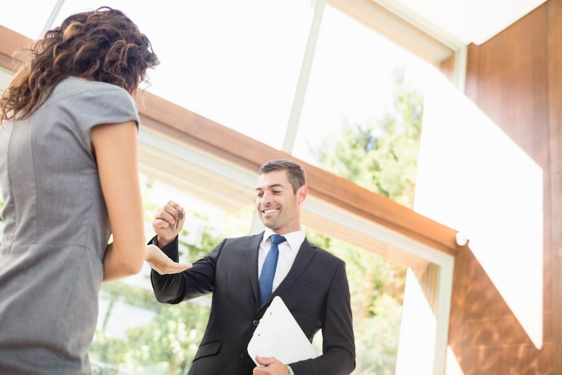 A man in a suit and tie is shaking hands with a woman