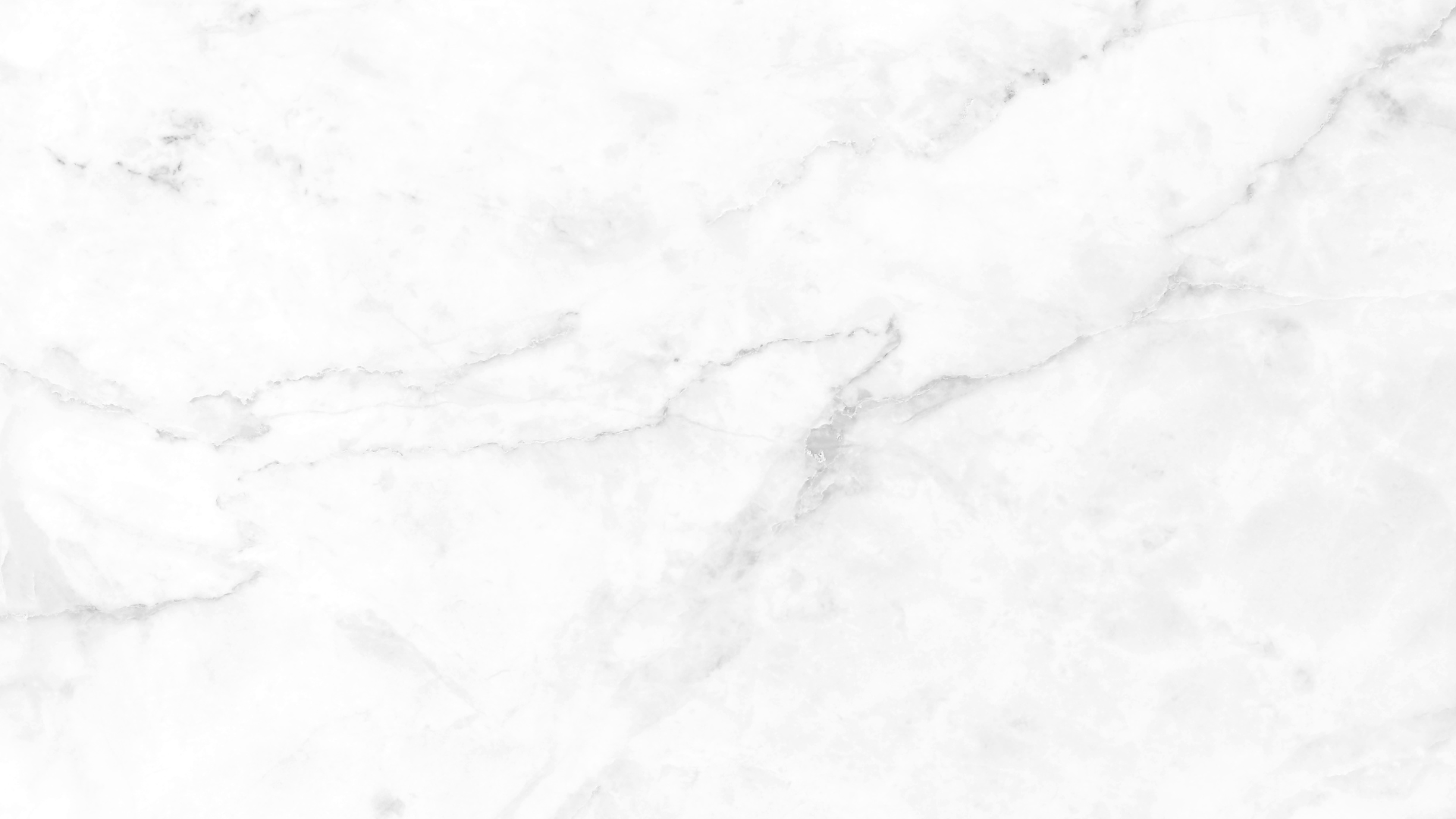 White marble-like textured surface with faint gray veining.