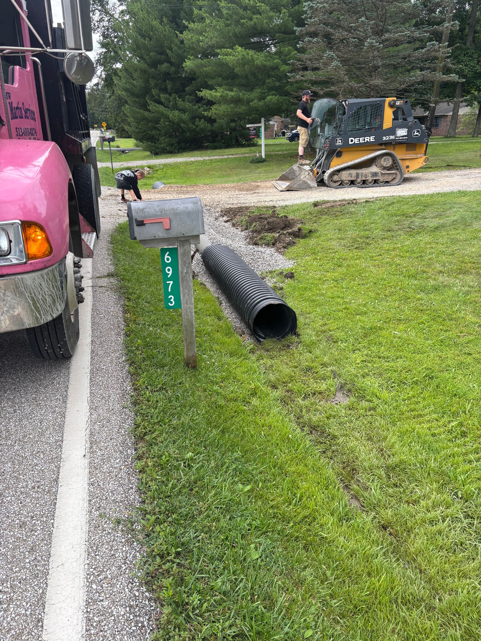Culvert pipe being installed under a gravel driveway in Southwest Ohio by MW Martin Services