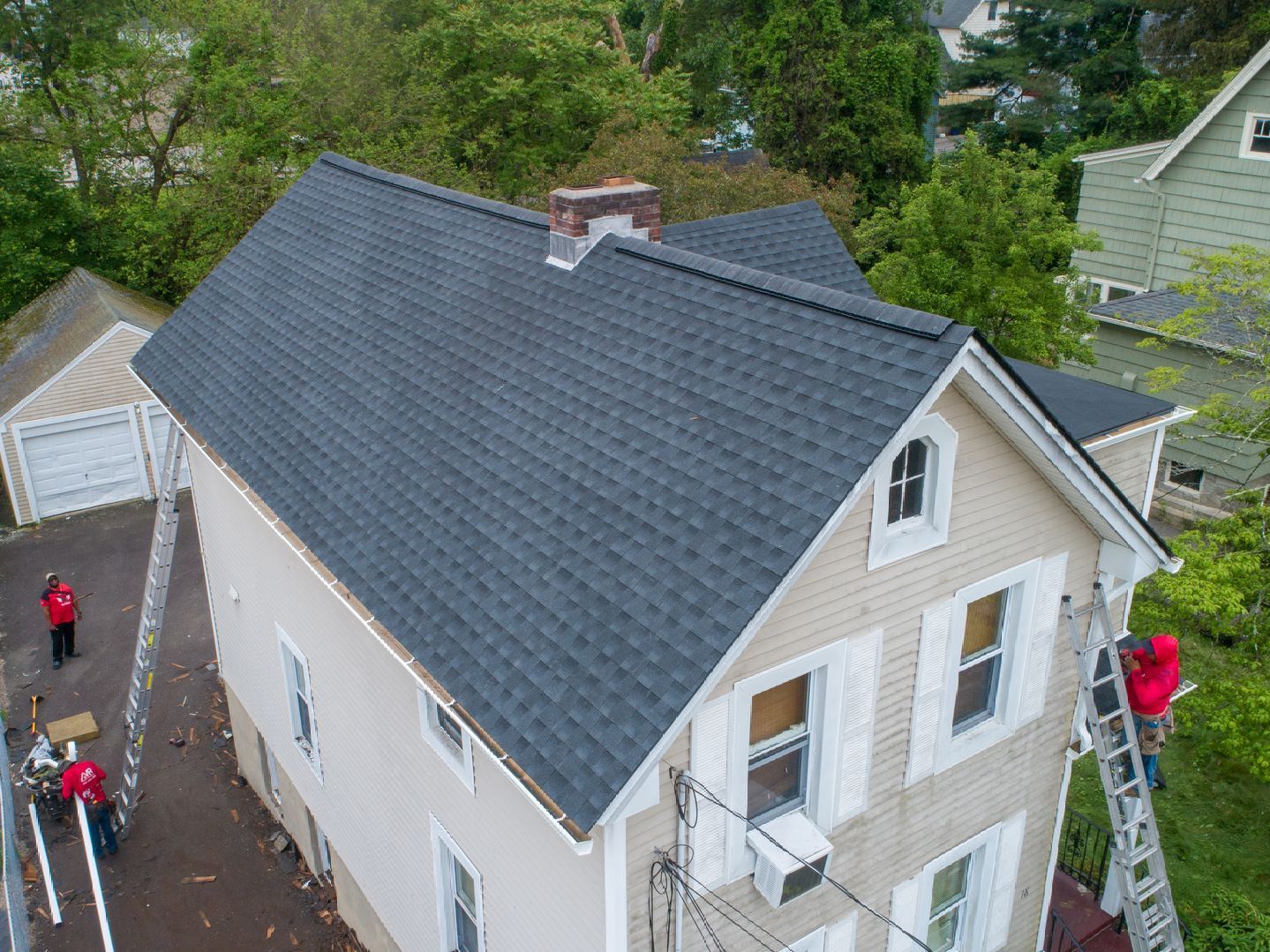 Manny Roofing team replacing a roof.