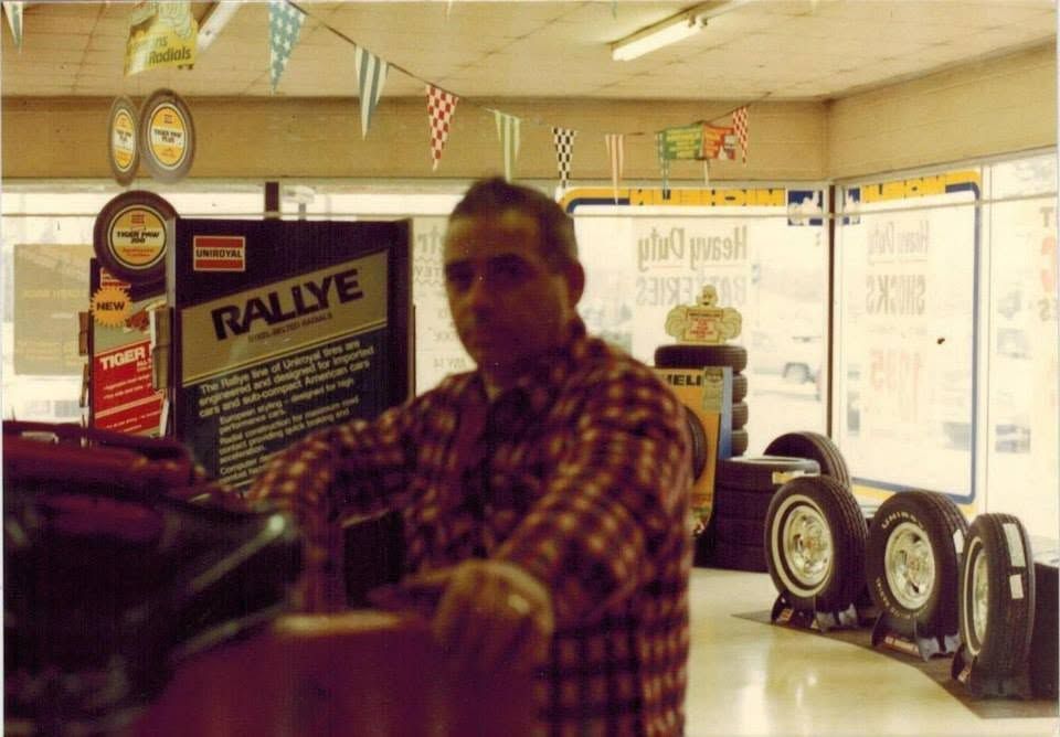 Man in plaid shirt standing in an auto parts store | Westside Tire & Service