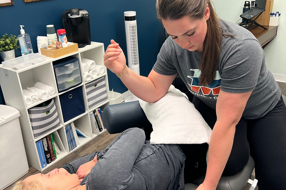 A woman is giving a person a massage in a room. A woman is giving a person a massage in a room.