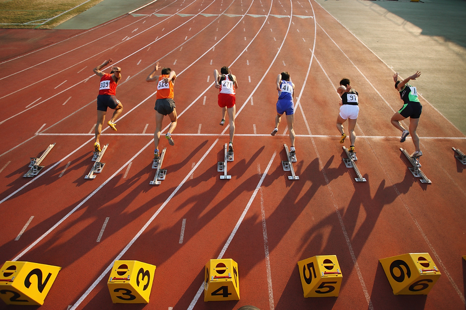 A group of athletes are getting ready to run on a track A group of athletes are getting ready to run on a track