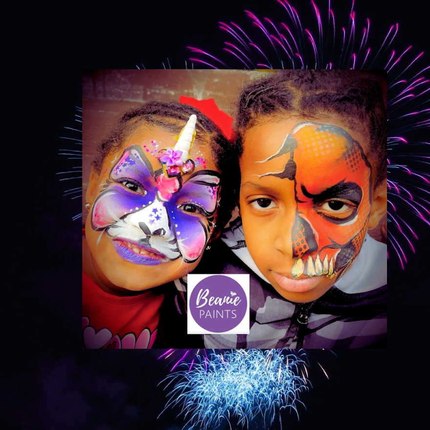 Two children with colorful face paint in front of fireworks, with a Beanie Paints logo in the center