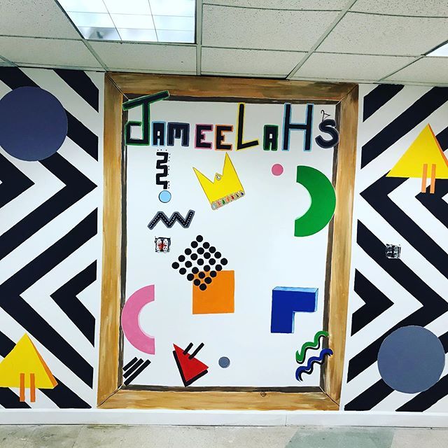 Decorative wall art mural with geometric patterns, colorful shapes, and the word “JAMELAHS” on a white center panel