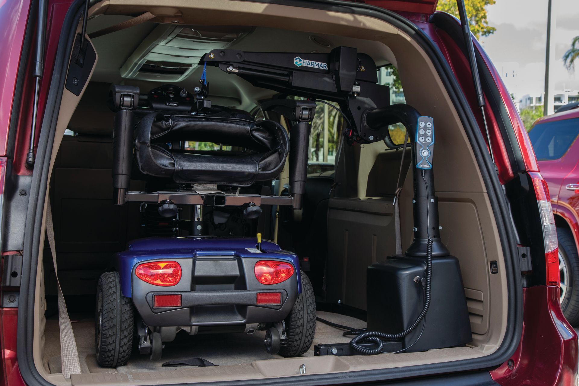 SUV trunk packed with a child’s off-road toy Jeep and a folded stroller or chair, rear hatch open