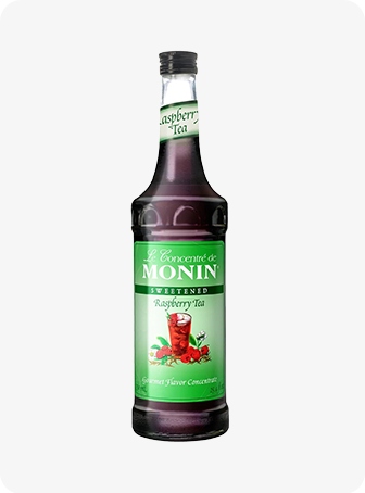 Bouteille de sirop de pomme verte Monin avec une étiquette verte sur fond blanc